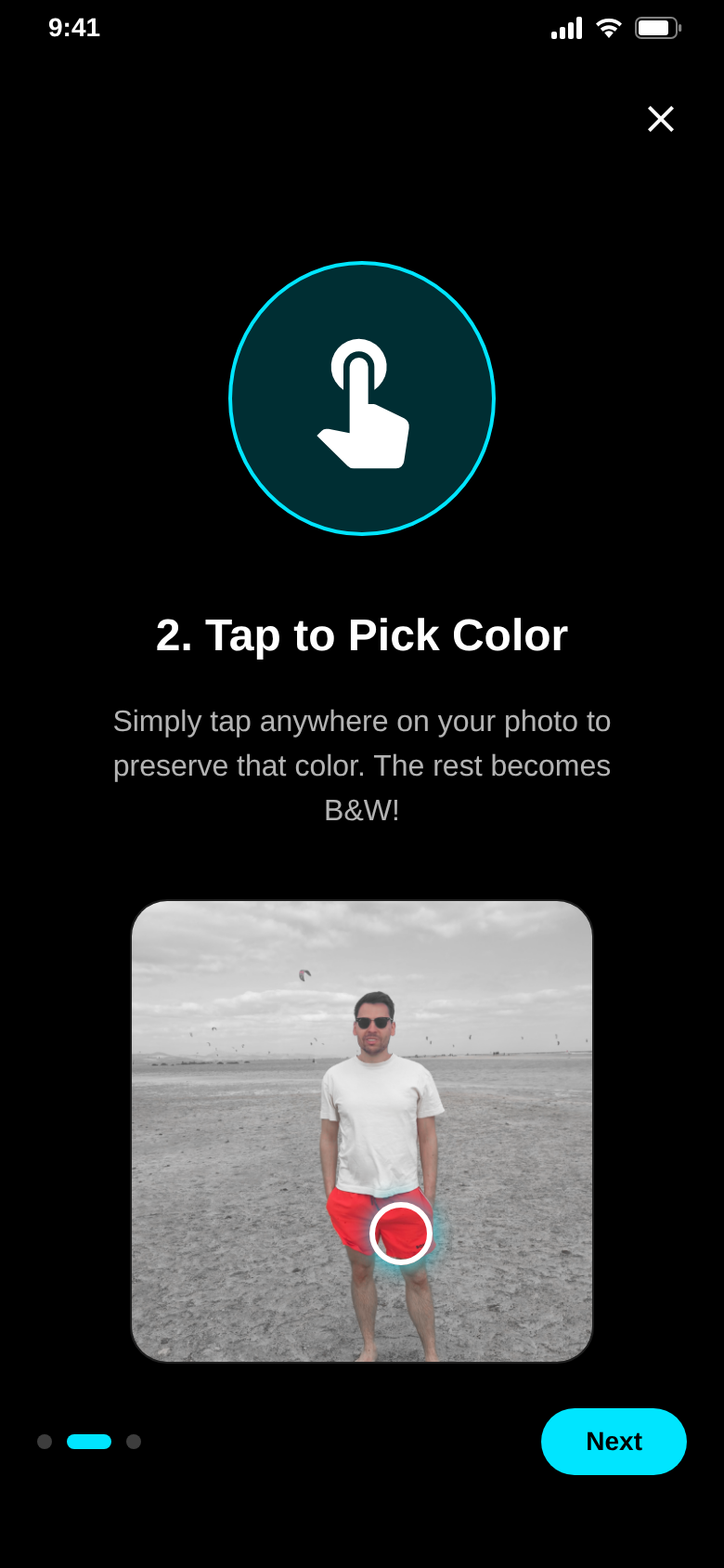 Tutorial step "Tap to Pick Color": a tap on the red shorts keeps that color, the rest of the photo is black and white